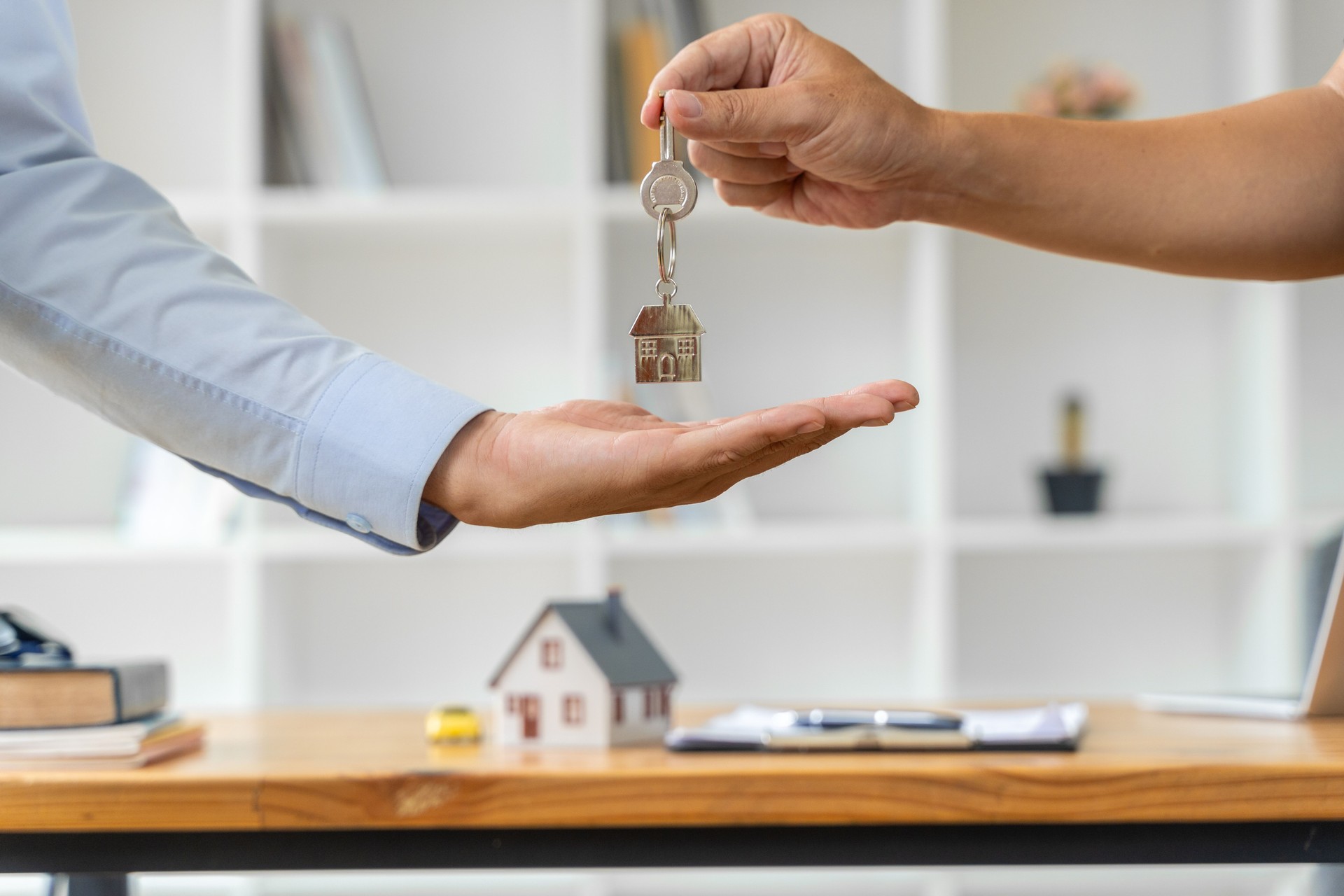 Close up hand of a male real estate agent holding a check